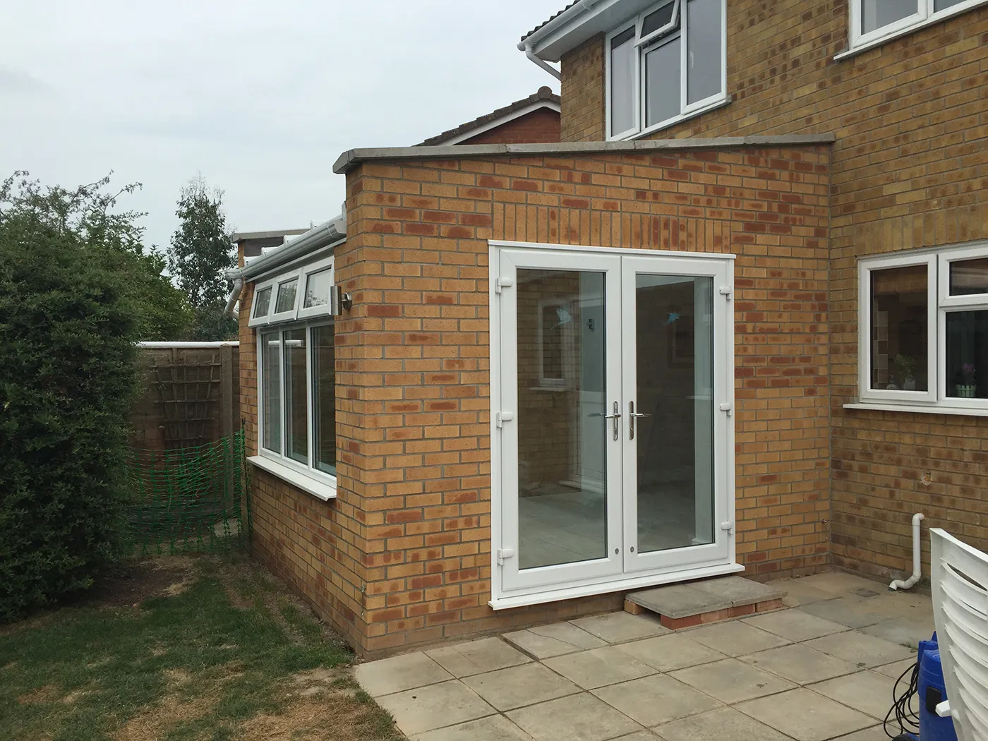 A brick house with a patio and a patio door.
