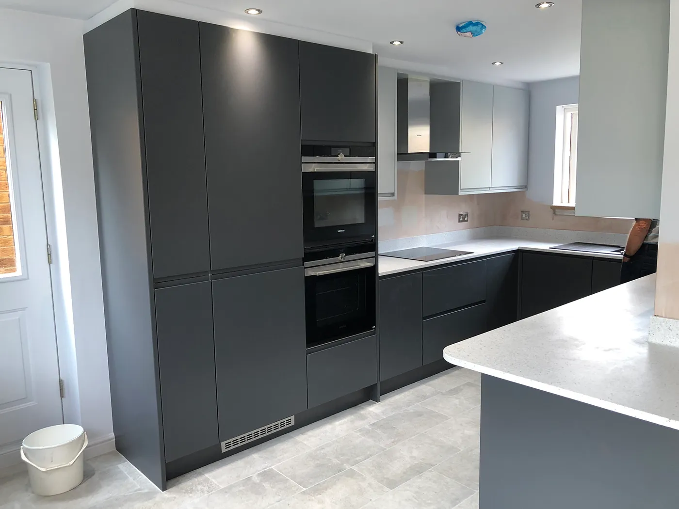 A kitchen with a stove, sink, and oven.