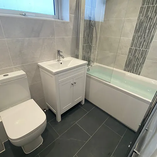 a bathroom with a toilet, sink, and bathtub